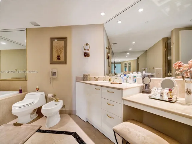 a bathroom with a double vanity sink mirror and toilet