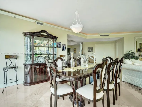a view of a dining room with furniture and a window