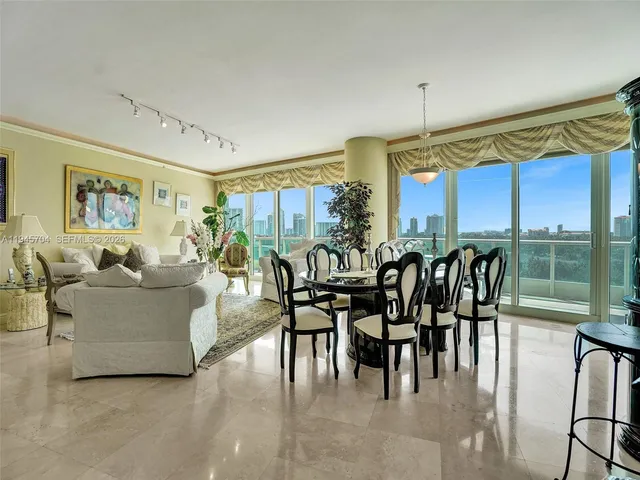 a living room with lots of furniture and a large window
