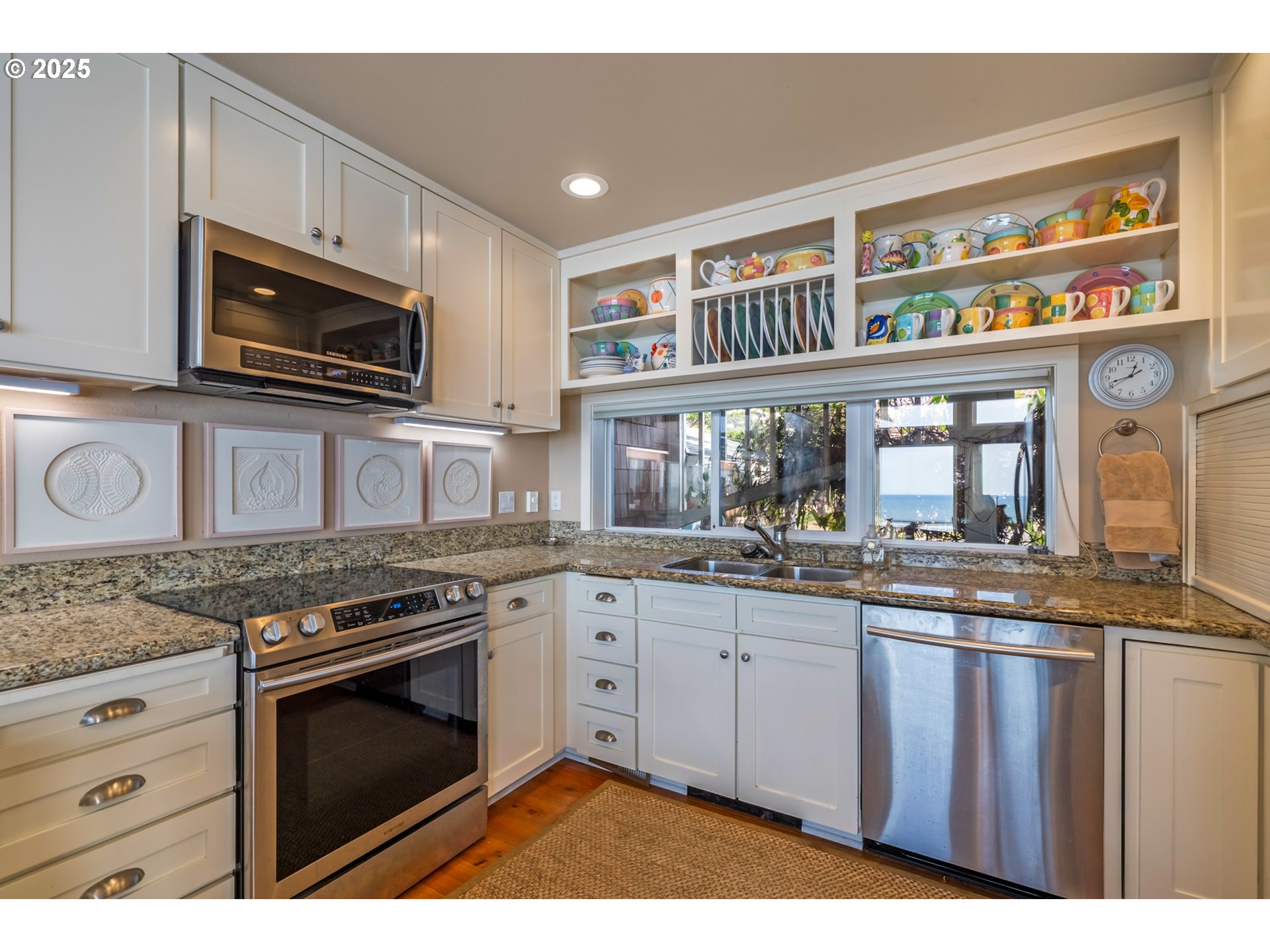 5235 Capes Loop Oceanside, OR 97141 - Photo 11 of 48 a kitchen with stainless steel appliances granite countertop a stove and a microwave