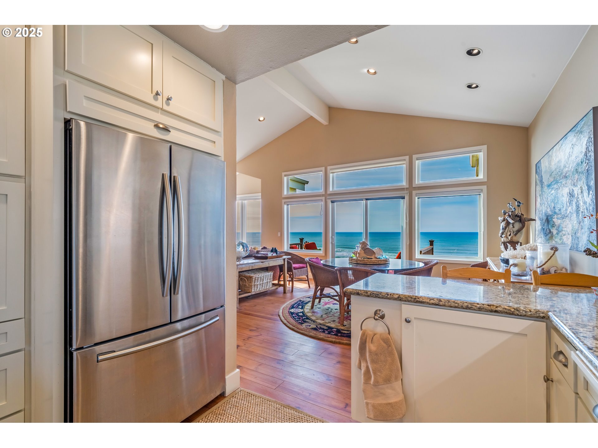 5235 Capes Loop Oceanside, OR 97141 - Photo 12 of 48 a kitchen with stainless steel appliances granite countertop a refrigerator and a sink