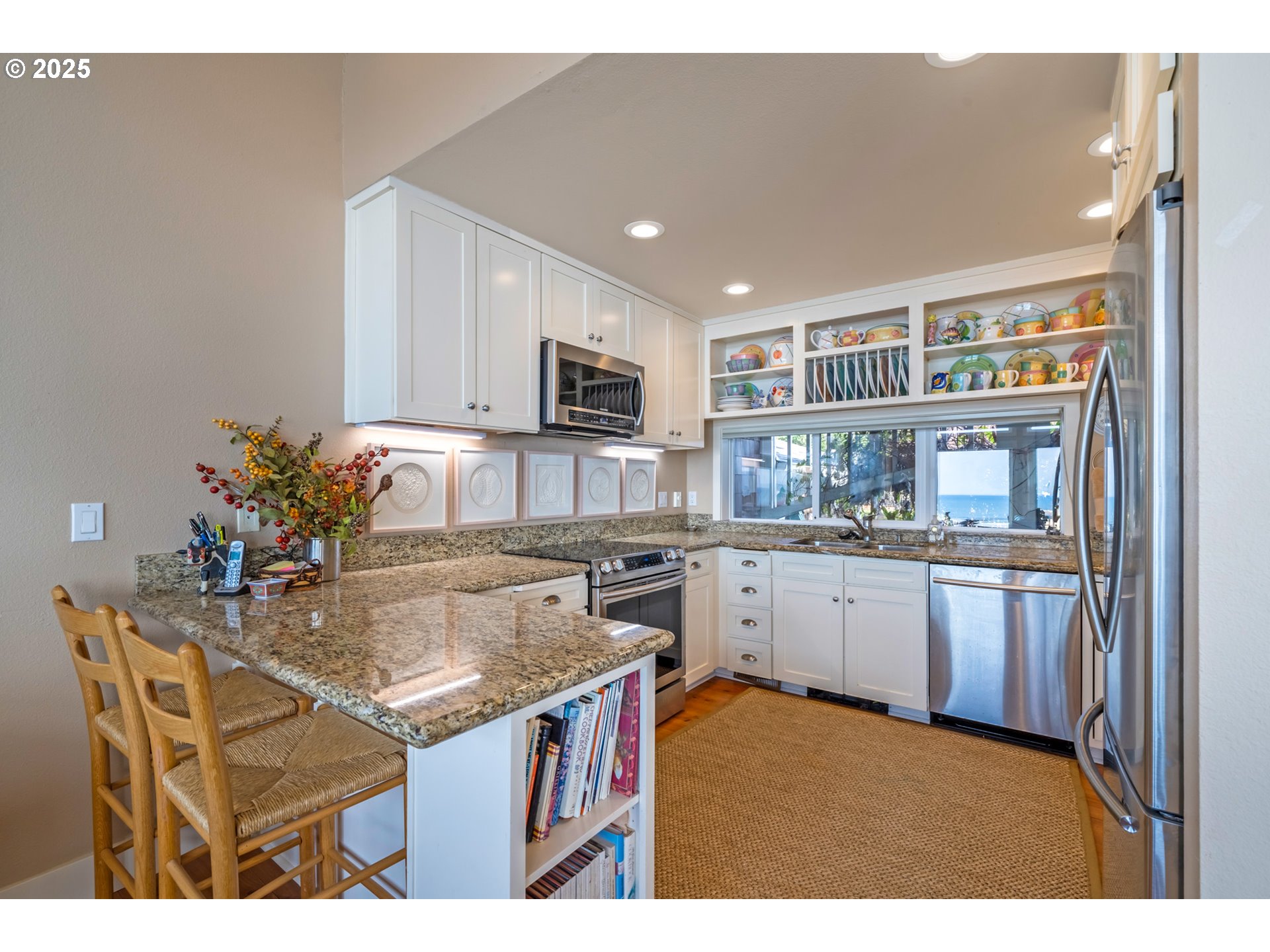 5235 Capes Loop Oceanside, OR 97141 - Photo 13 of 48 a kitchen with kitchen island granite countertop a sink stove and refrigerator