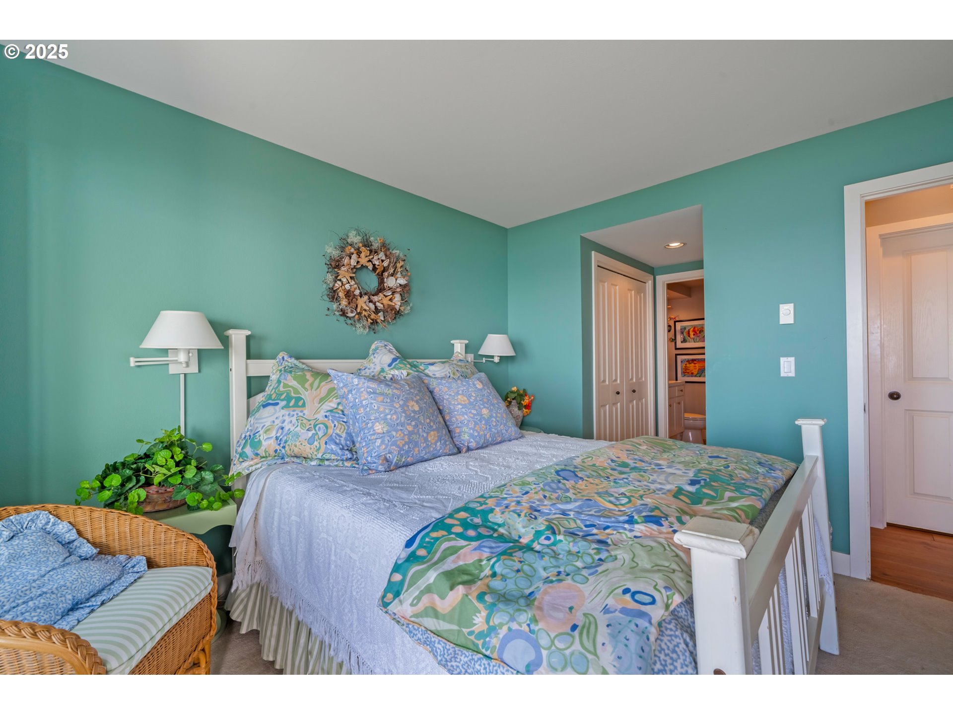 5235 Capes Loop Oceanside, OR 97141 - Photo 31 of 48 a bed room with a bed mirror and a lamp