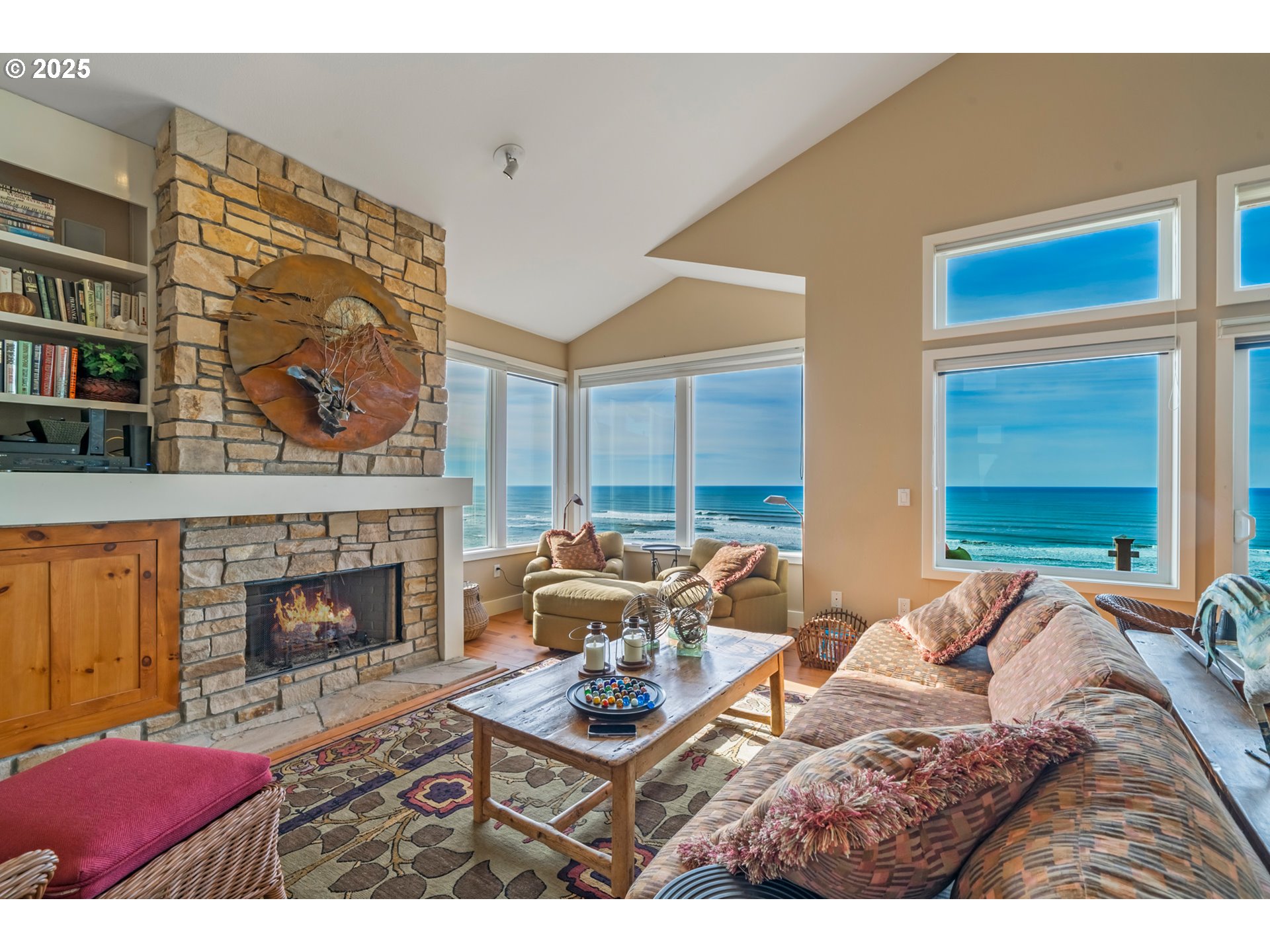 5235 Capes Loop Oceanside, OR 97141 - Photo 4 of 48 a living room with furniture a fireplace and a large window