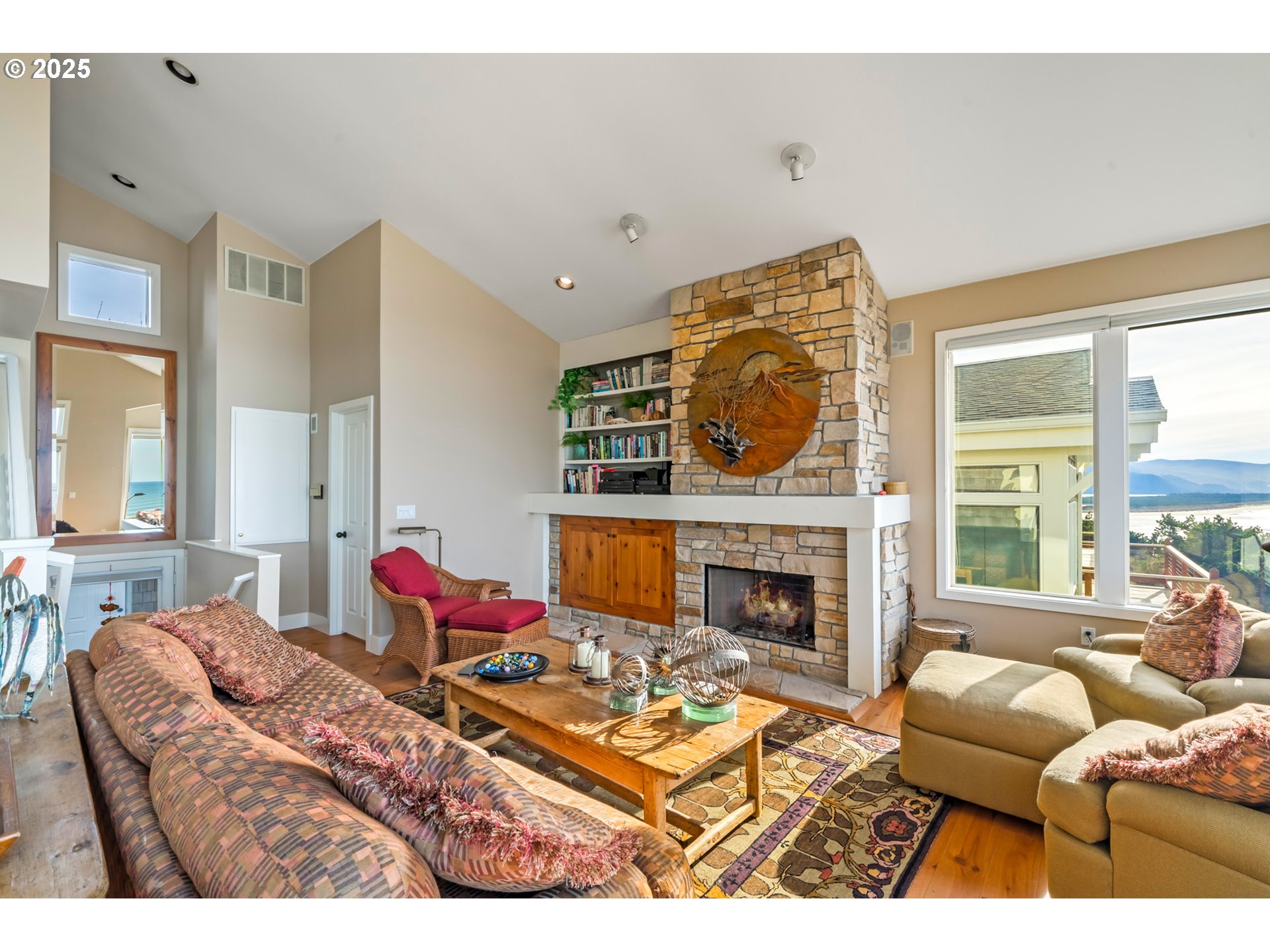 5235 Capes Loop Oceanside, OR 97141 - Photo 6 of 48 a living room with furniture a fireplace and windows