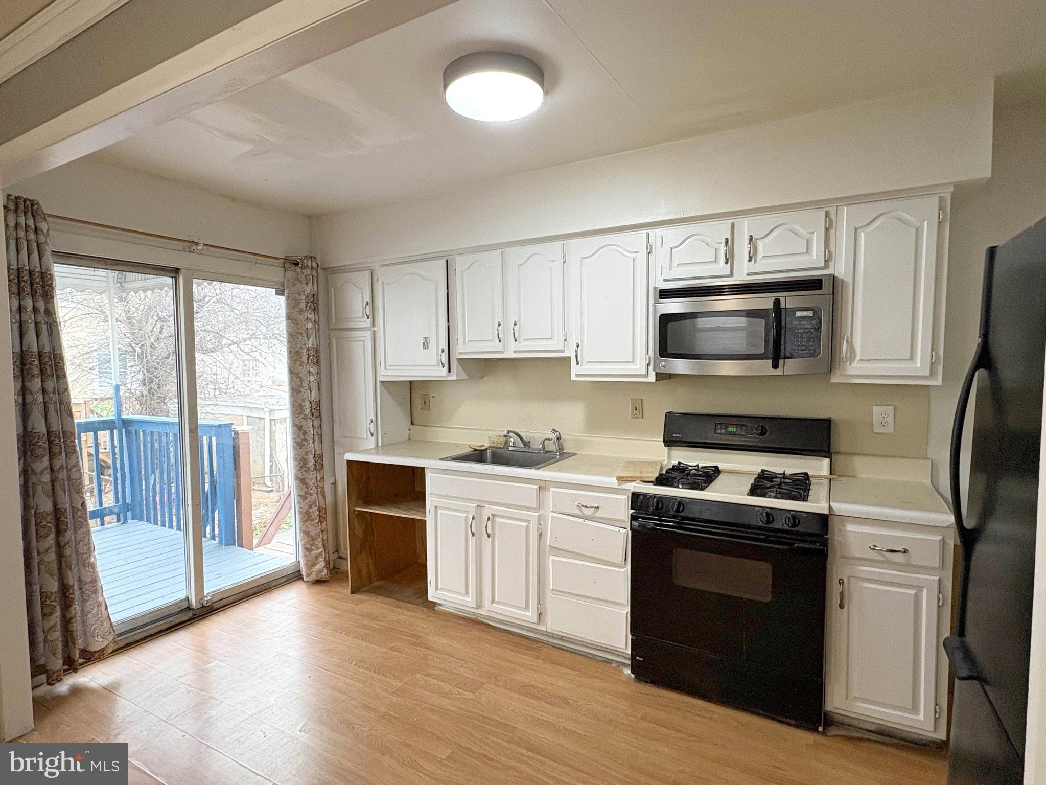 233 Barrington Road Upper Darby, PA 19082 - Photo 11 of 14 a kitchen with a sink a microwave and cabinets