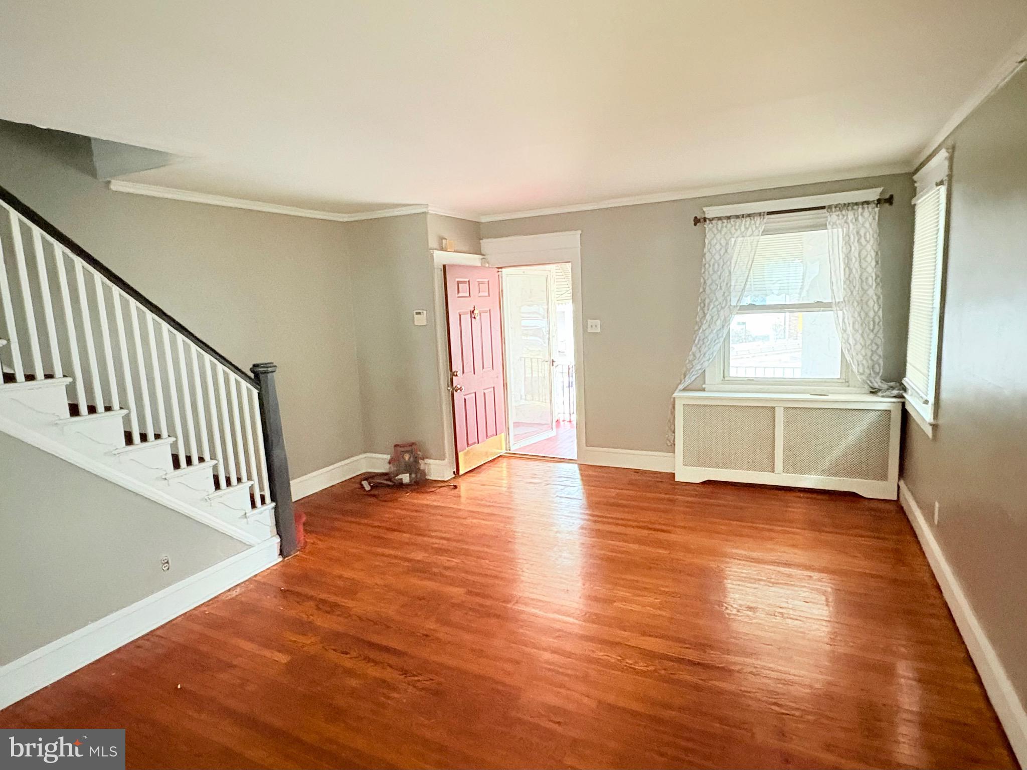 233 Barrington Road Upper Darby, PA 19082 - Photo 2 of 14 an empty room with wooden floor and windows