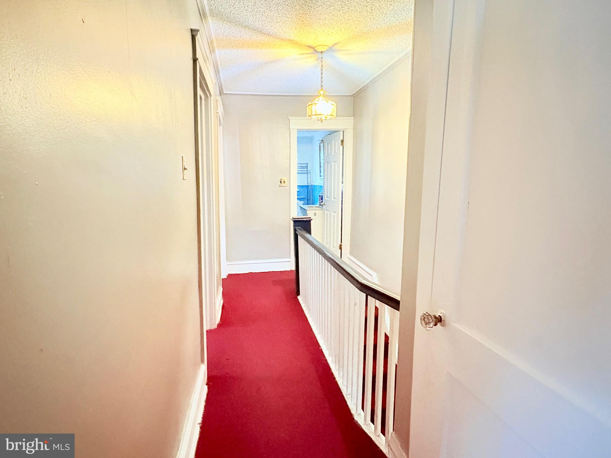 233 Barrington Road Upper Darby, PA 19082 - Photo 7 of 14 a view of a hallway with wooden floor and staircase
