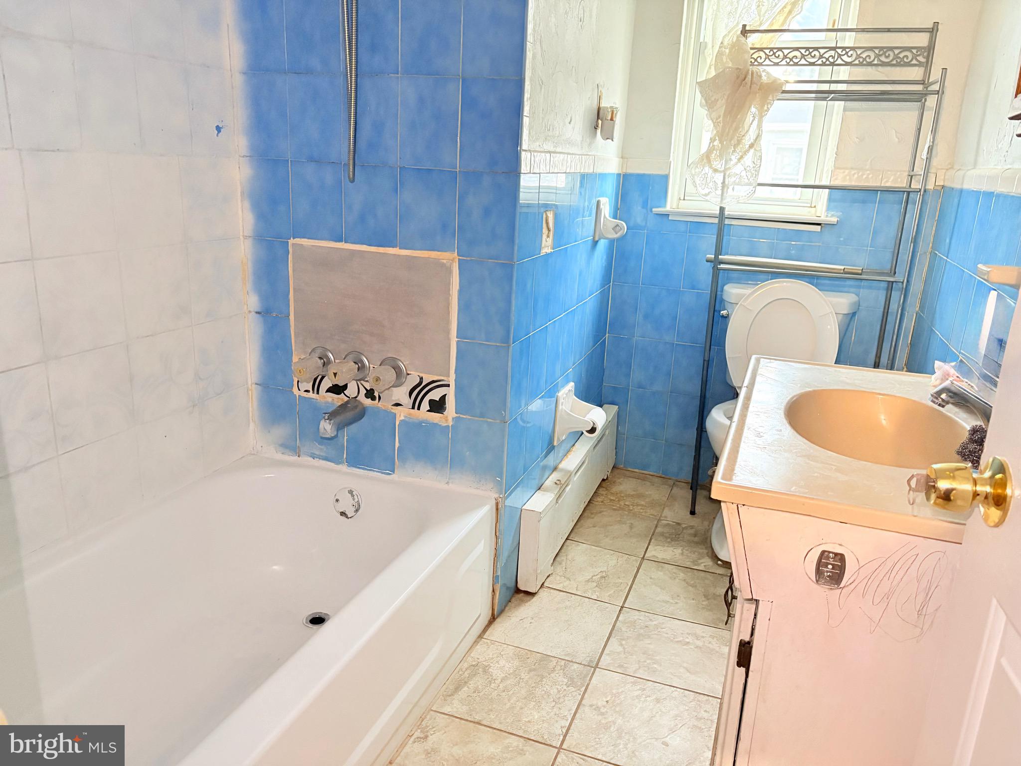 233 Barrington Road Upper Darby, PA 19082 - Photo 8 of 14 a en suite bathroom with a tub sink and mirror