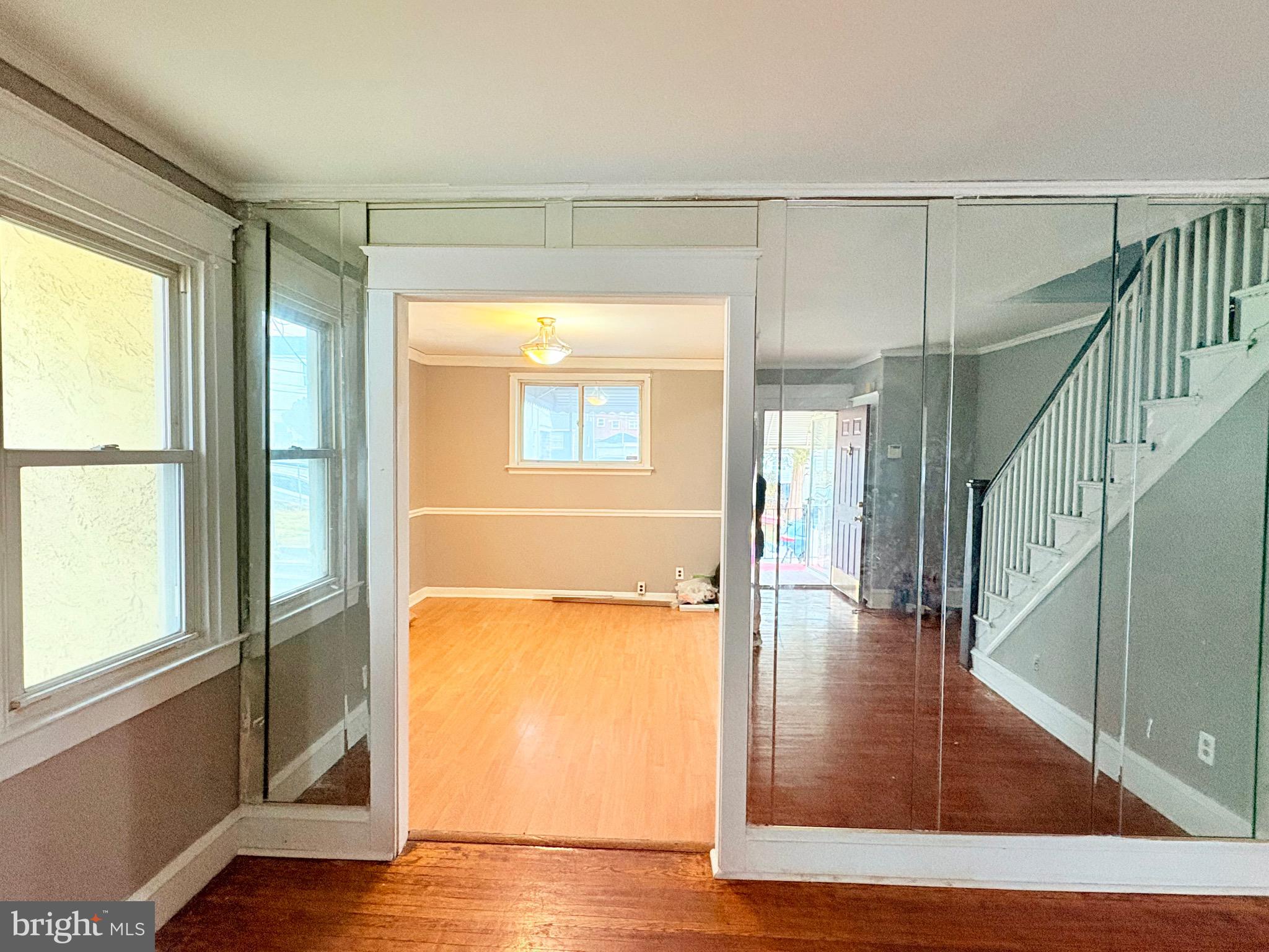 233 Barrington Road Upper Darby, PA 19082 - Photo 9 of 14 a view of a hallway with wooden floor and staircase