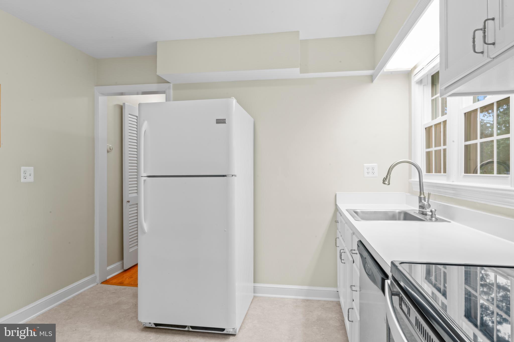 12131 Waples Mill Road Oakton, VA 22124 - Photo 15 of 40 a kitchen with a refrigerator and a sink