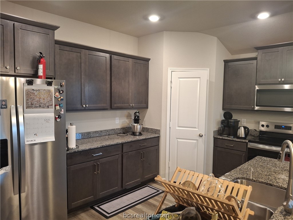 1864 Taggart Trail Bryan, TX 77807 - Photo 4 of 12 a kitchen with a refrigerator and a sink