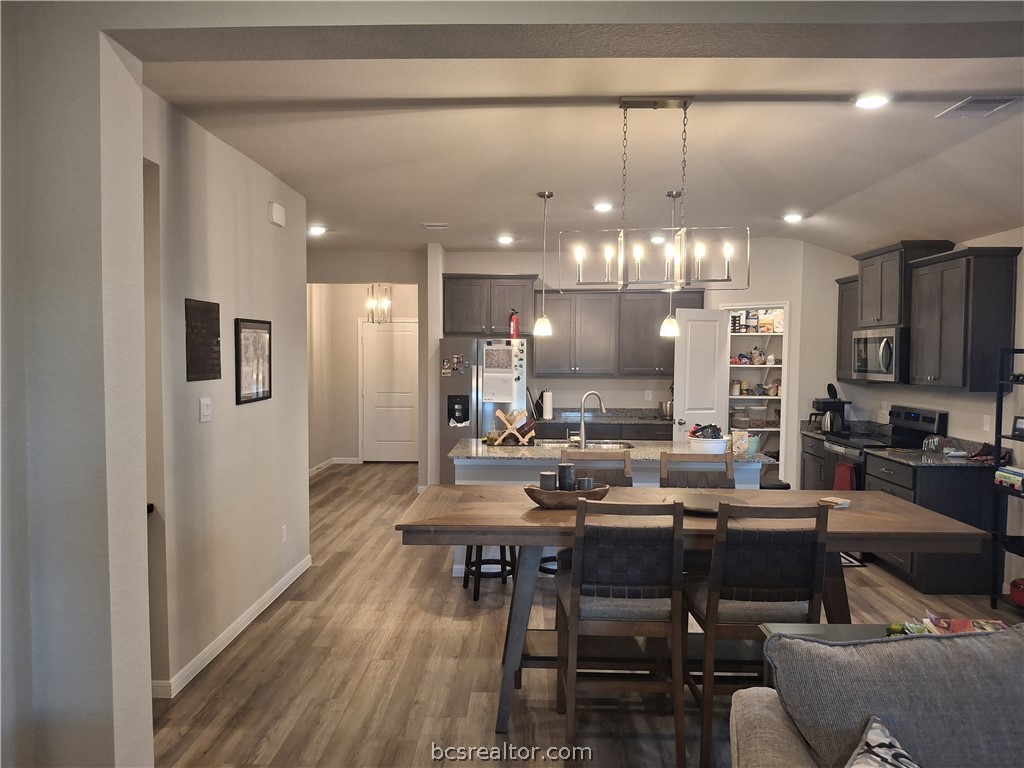 1864 Taggart Trail Bryan, TX 77807 - Photo 6 of 12 a kitchen with a dining table chairs stainless steel appliances and cabinets
