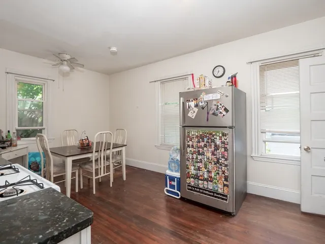 a view of a workspace with furniture and wooden floor