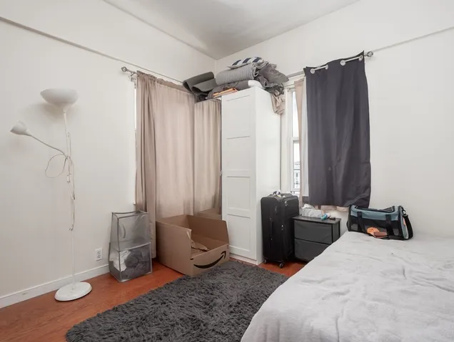 a bedroom with furniture and a window