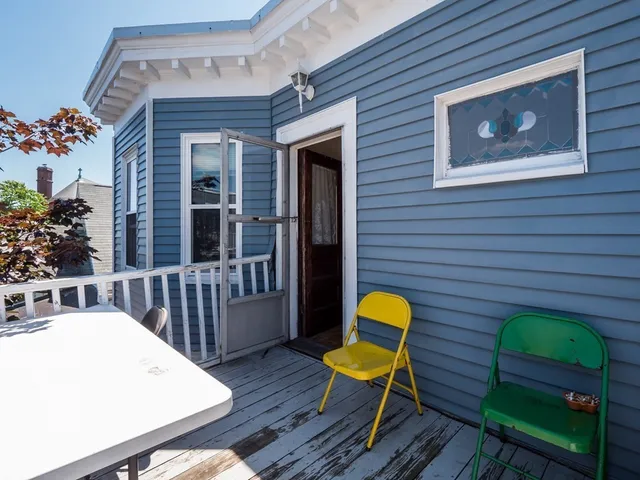 a view of a wooden chairs and a back yard of the house