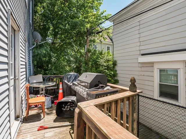 a view of roof deck with furniture and wooden deck