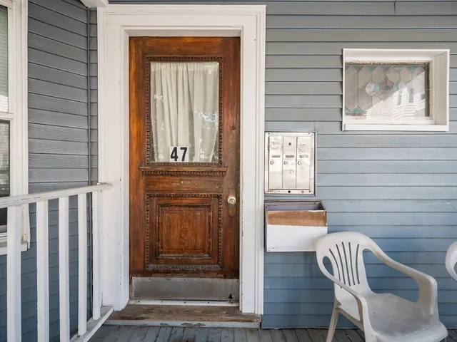 a front view of a house with outdoor seating