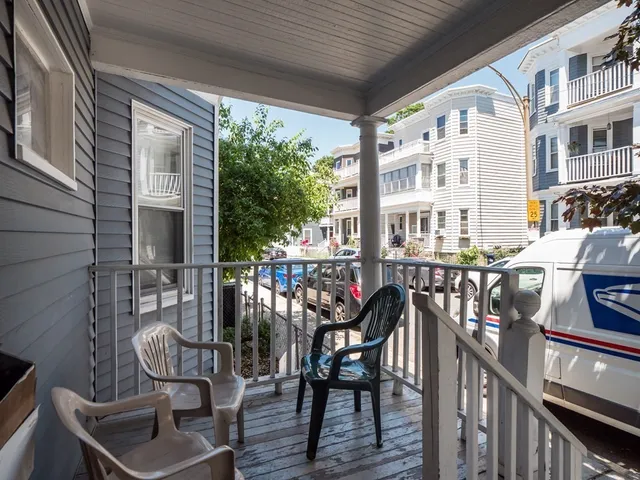 a view of a chairs and table in the balcony