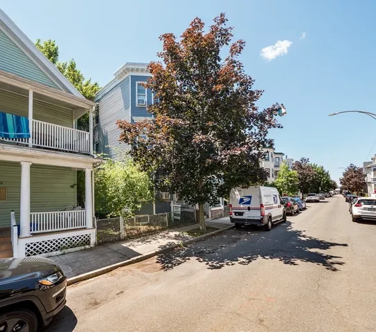 a view of street with parked cars