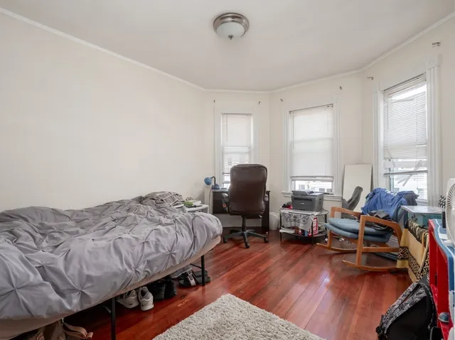 a bedroom with bed and a window