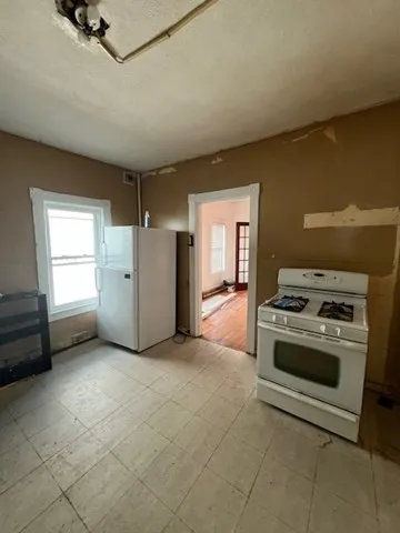 a kitchen with a stove a sink and a refrigerator