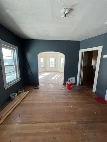 a view of a livingroom with wooden floor and a ceiling fan