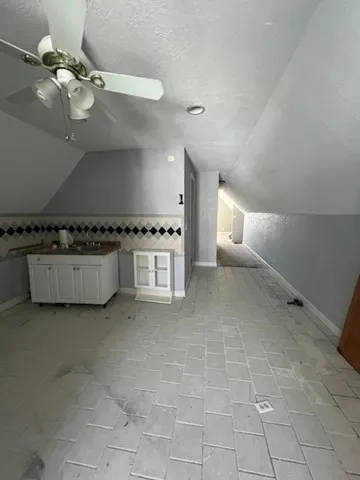 a view of a kitchen with a stove cabinets and a floor to ceiling window