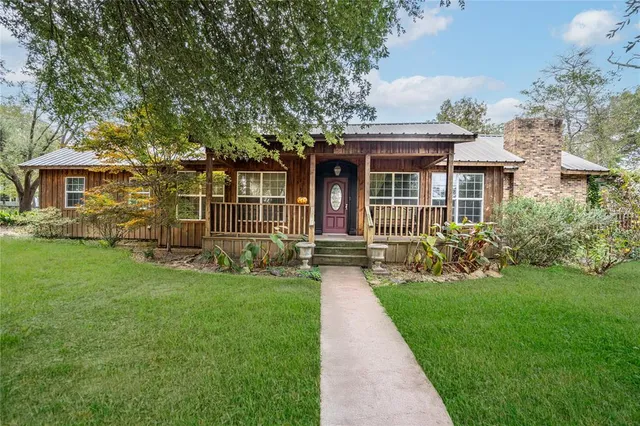 a front view of house with yard and green space
