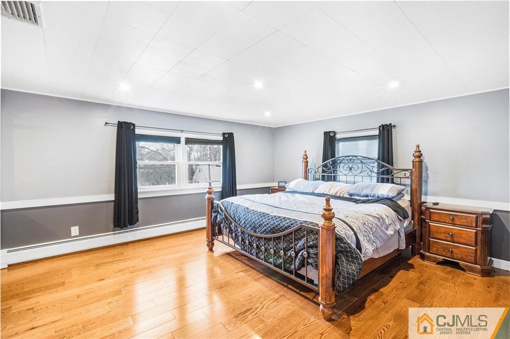 151 East Cliff Road Colonia, NJ 07067 - Photo 21 of 29 a bed sitting in a spacious bedroom next to a window