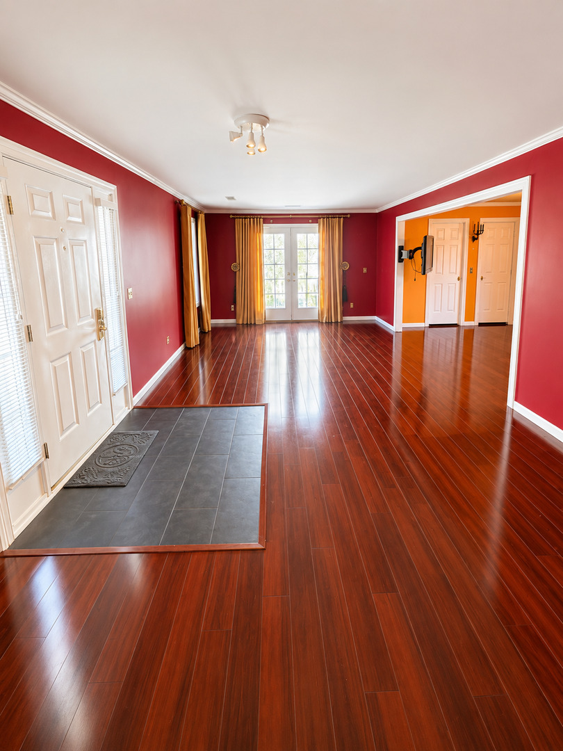 354 19th Place Clinton, IA 52732 - Photo 3 of 16 a view of an empty room with wooden floor and a window