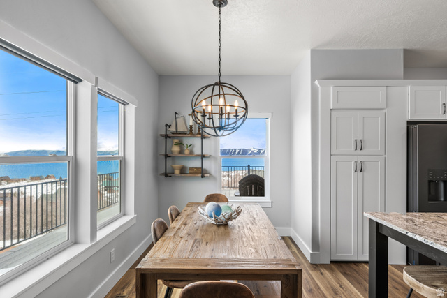 1343 North Trapper Loop Garden City, UT 84028 - Photo 39 of 56 Dining area with a water view, hanging lights, and light wood-style floors