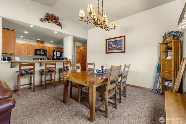a view of a dining room with furniture and a chandelier