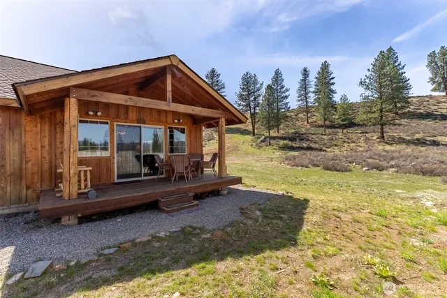 a view of the house with backyard and porch
