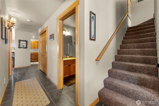 a view of a hallway with wooden floor and staircase