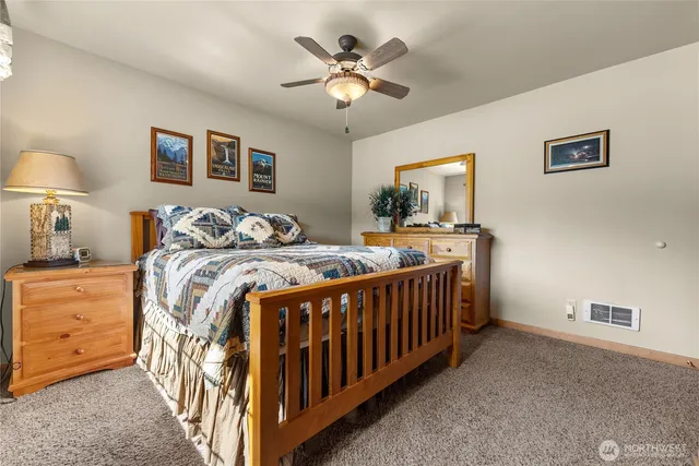 a bedroom with bed and a chandelier
