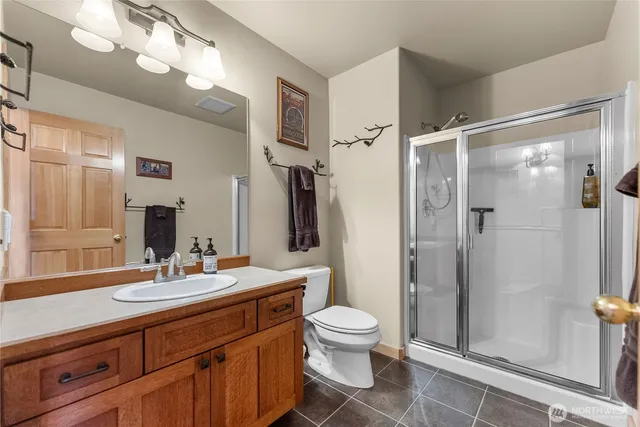 a bathroom with a double vanity sink toilet and shower