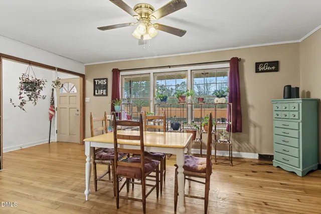 a view of a livingroom with wooden floor and furniture