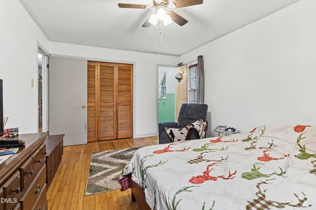 a bedroom with a bed and wooden floor