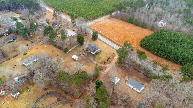 a front view of house with yard and trees around