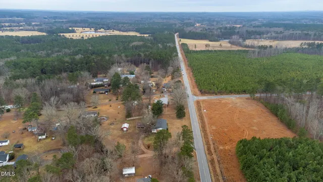 a wooden house with trees in the background
