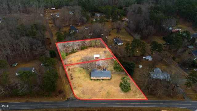 a aerial view of a house with a yard