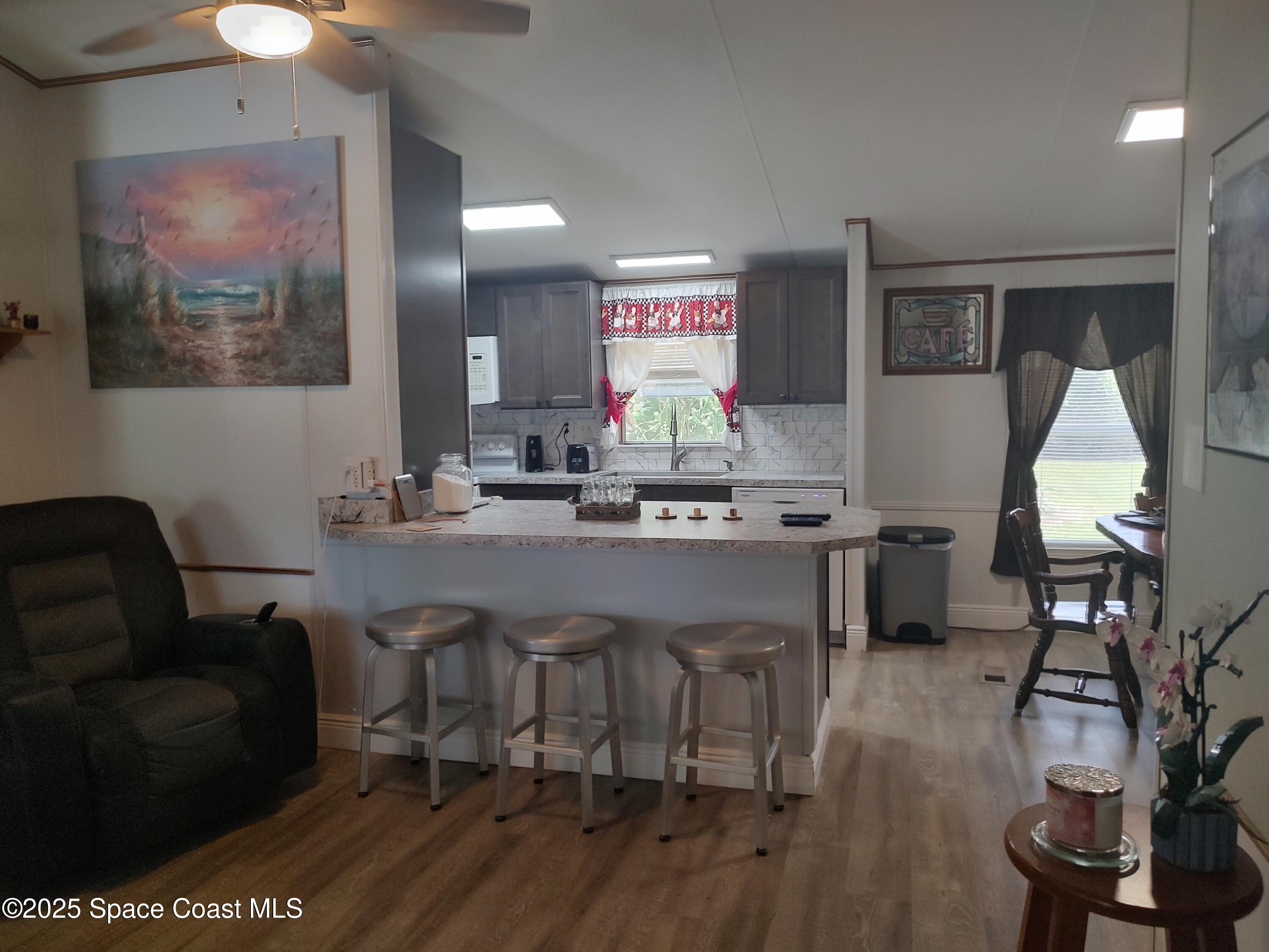 3314 Nab Street Mims, FL 32754 - Photo 11 of 27 a living room with furniture a piano and a flat screen tv