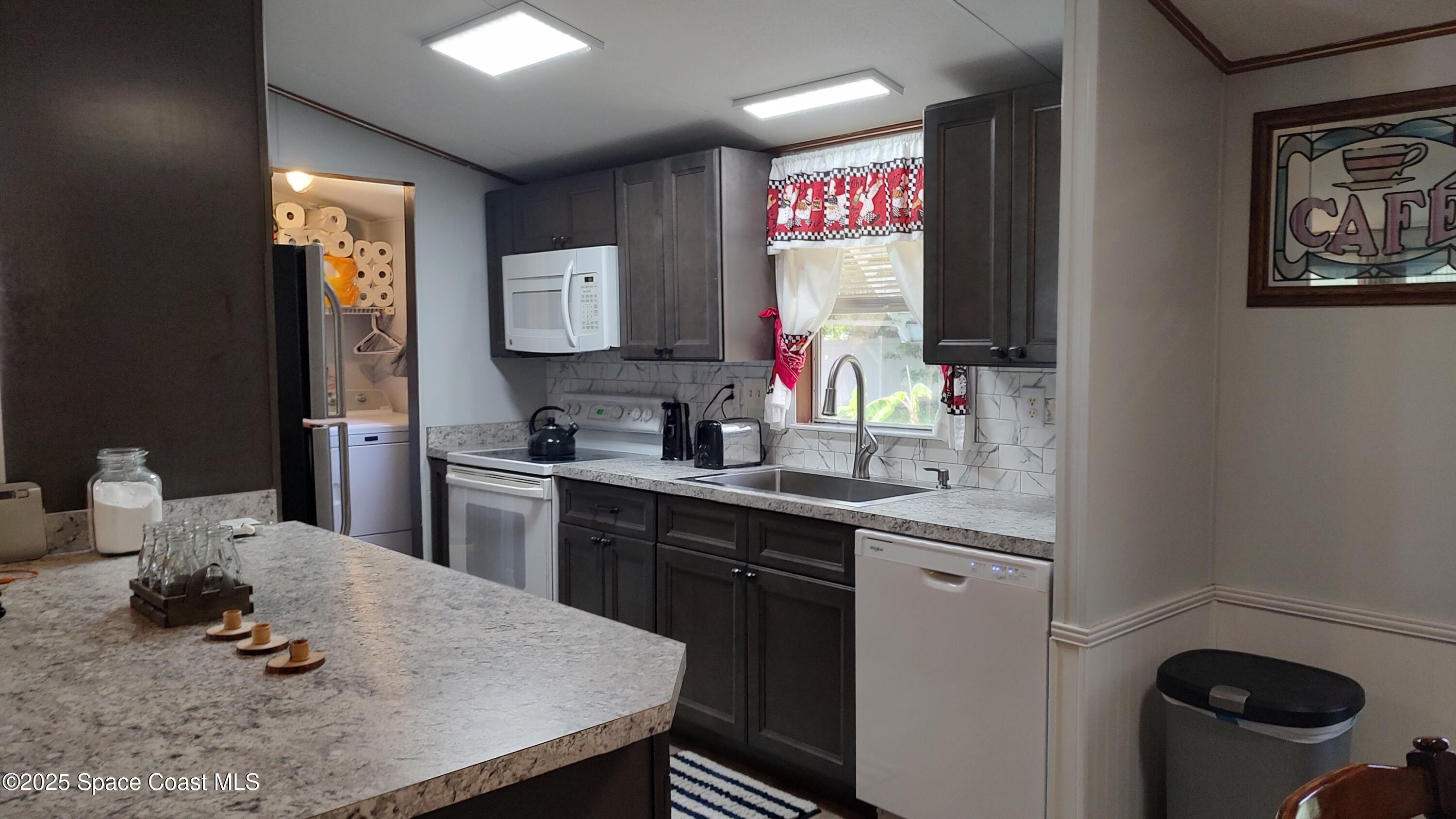 3314 Nab Street Mims, FL 32754 - Photo 2 of 27 a kitchen with a sink cabinets and window
