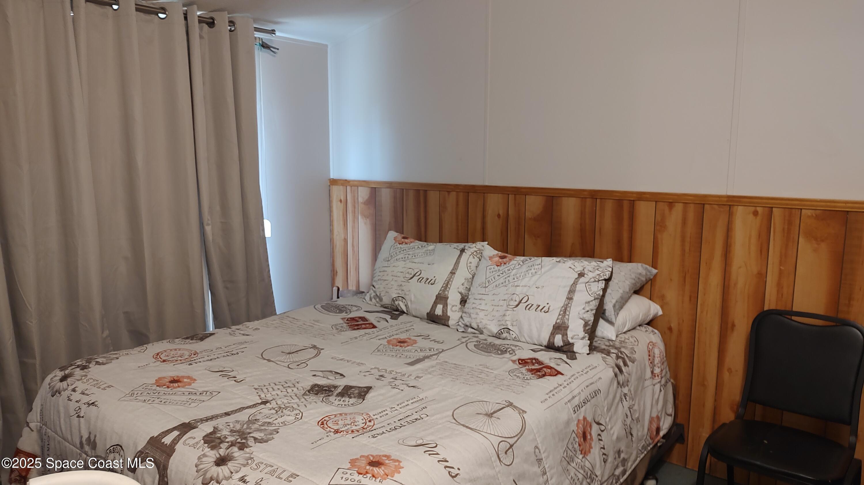 3314 Nab Street Mims, FL 32754 - Photo 25 of 27 a bed sitting in a bedroom next to a window and a curtain