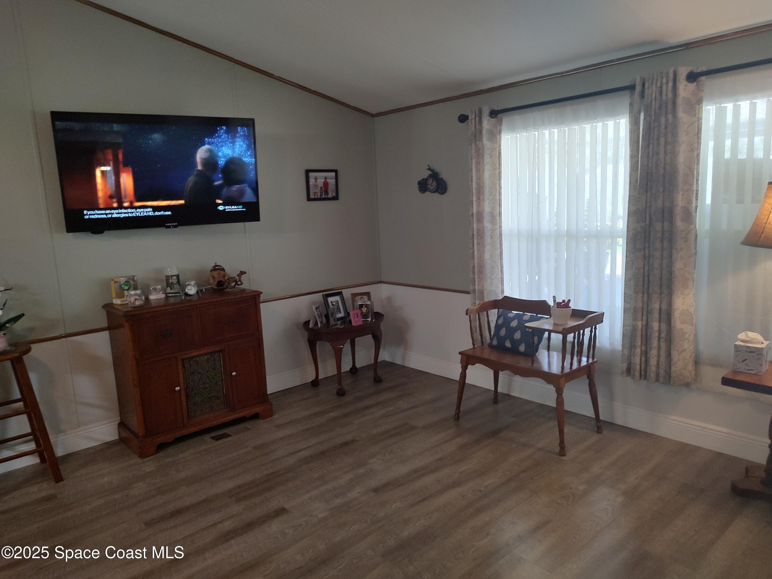 3314 Nab Street Mims, FL 32754 - Photo 9 of 27 a living room with furniture and a flat screen tv