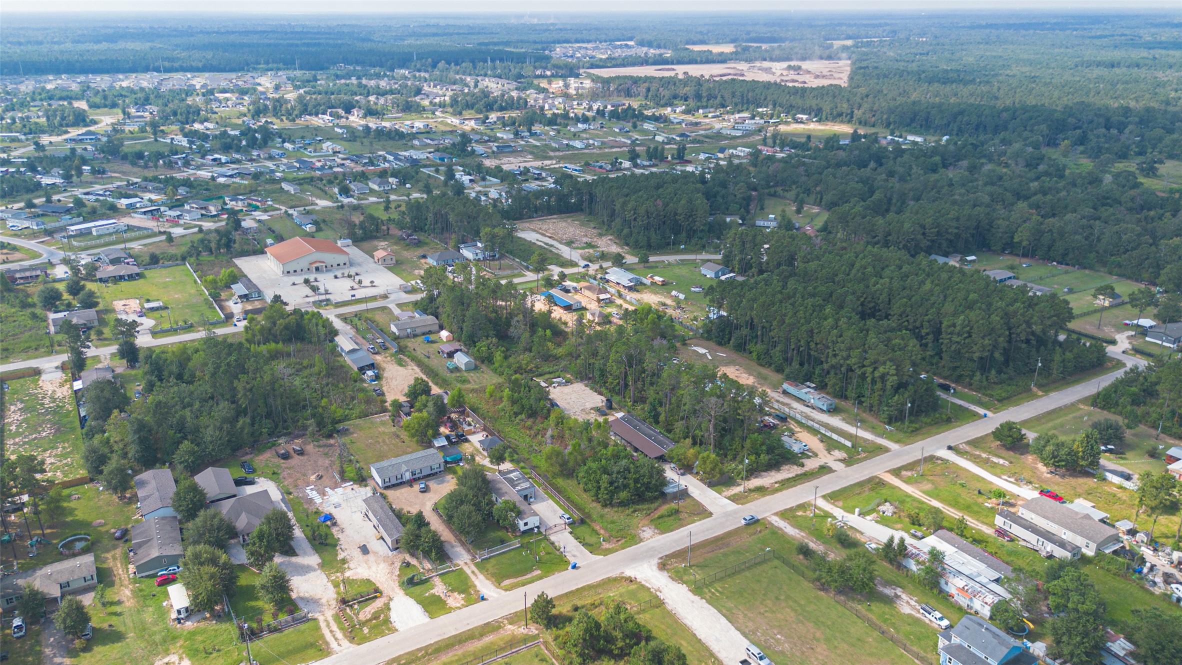 128 County Road 3548 Cleveland, TX 77327 - Photo 11 of 14 an aerial view of residential houses with outdoor space and river