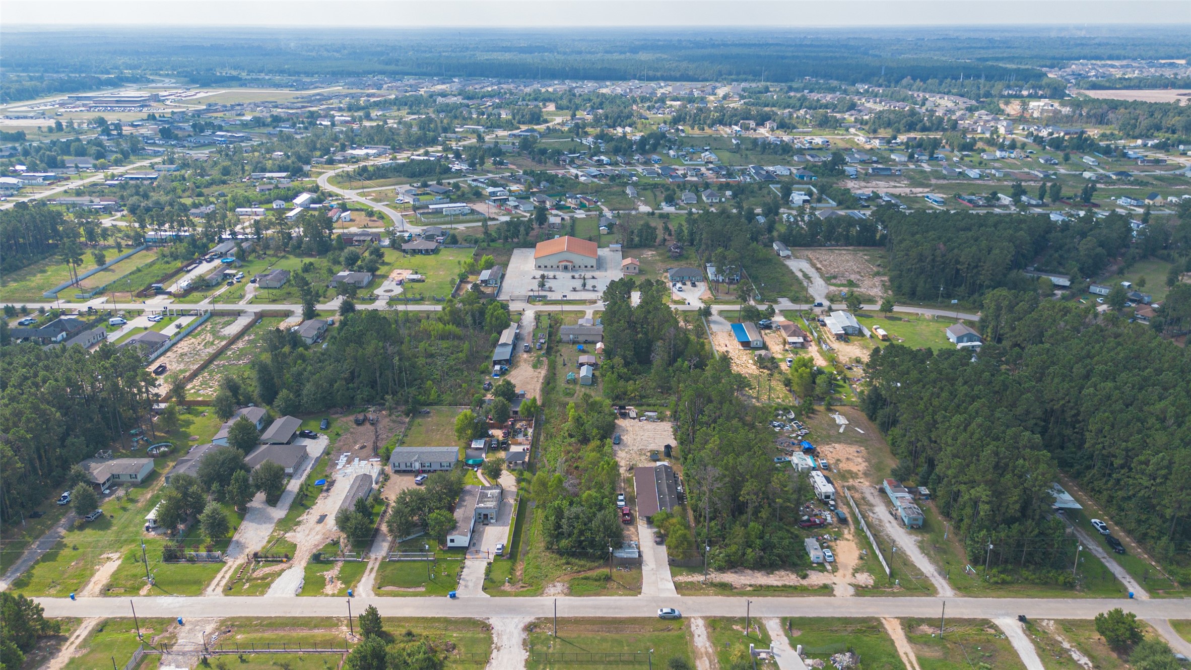 128 County Road 3548 Cleveland, TX 77327 - Photo 12 of 14 an aerial view of residential building and lake view