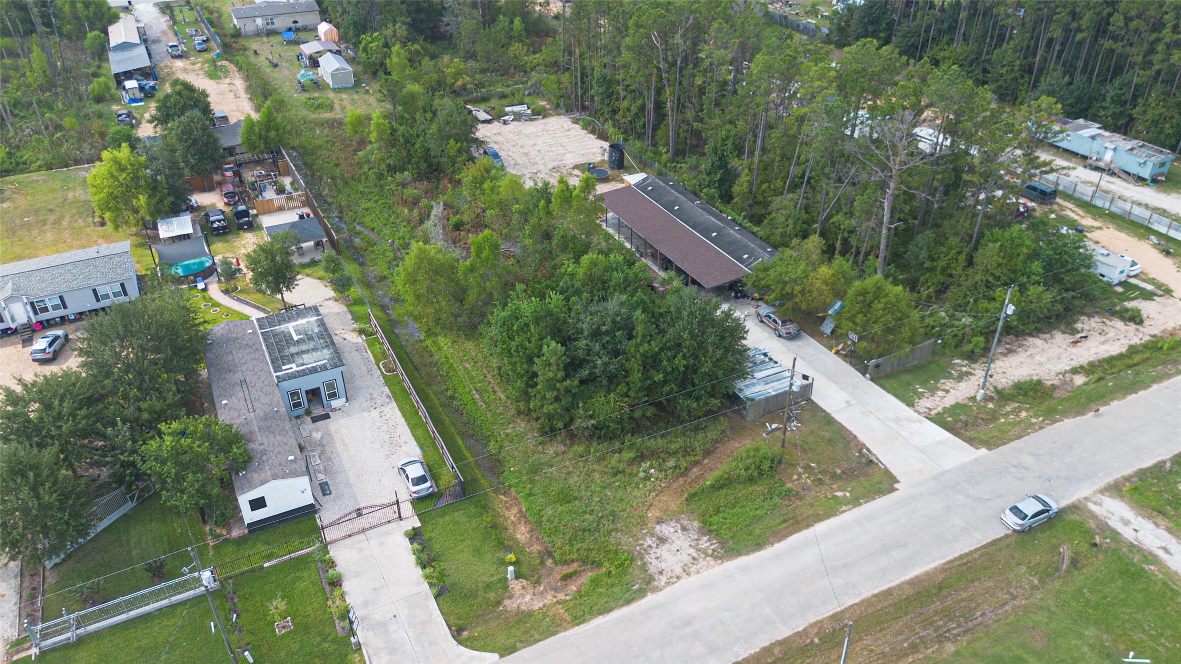 128 County Road 3548 Cleveland, TX 77327 - Photo 4 of 14 a view of a garden with swimming pool