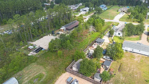 an aerial view of a house with a yard and lake view